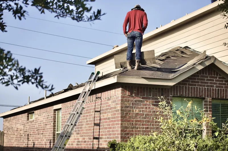 Professional roofer working on a residential roof in Carroll Heights